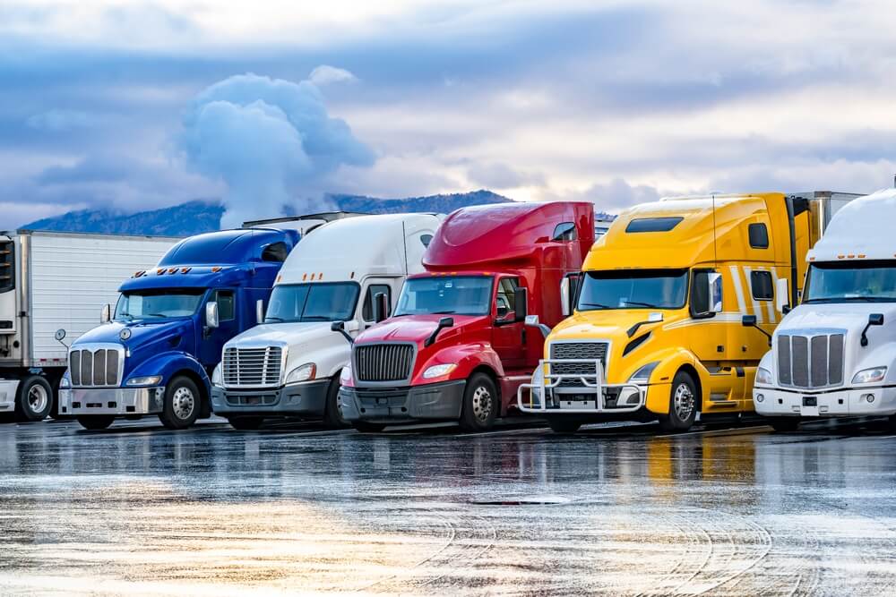 A row of multi colored trucks.